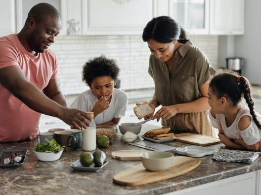 Family Eating Breakfast on Kitchen Island