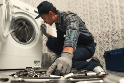 Man Repairing Washer
