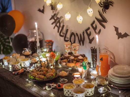 Table with Elaborate Snack Presentation Surrounded by Halloween Decorations