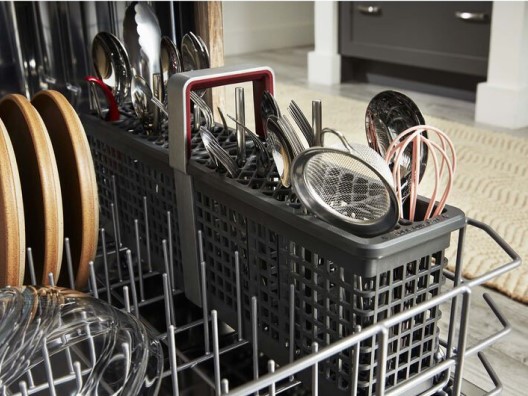 Dishwasher Bottom Rack Filled with Dishes and Utensils