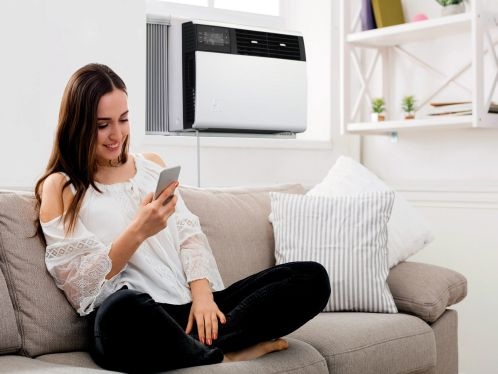 Woman Near Window Air Conditioner