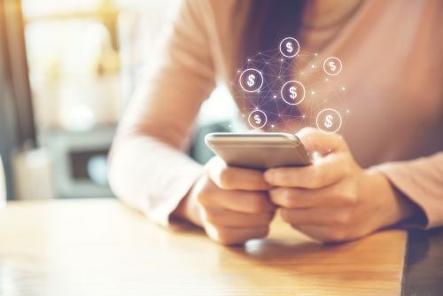 Woman Holding Phone with Dollar Signs Hovering