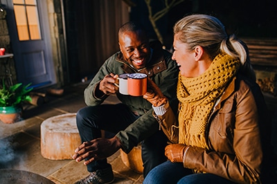 Man and Woman Drinking Cocoa Outside