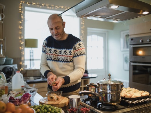 Man in Cozy Sweater Preparing Food in Kitchen