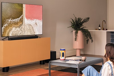 Woman Watching TV with Soundbar