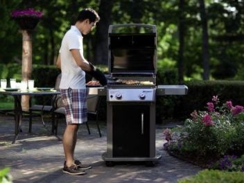 Man Cooking on Grill Outdoors