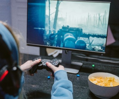 Shot of Woman Holding Gaming Controller and Playing First-Person Shooter Game