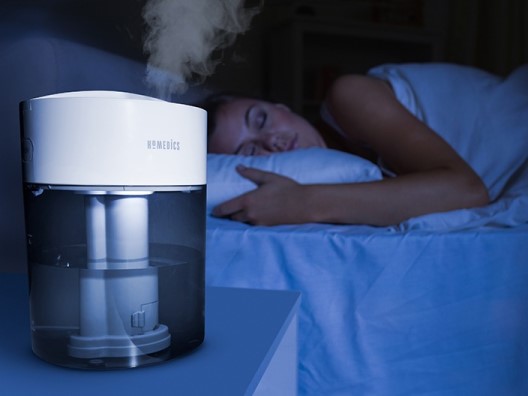 Woman Asleep in Bed with Humidifier Nearby
