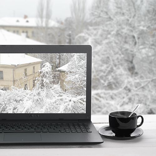 laptop by window with cup of coffee 