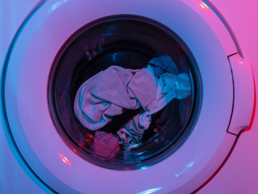 Closeup of Front of Dryer Illuminated By Pink and Blue Lighting