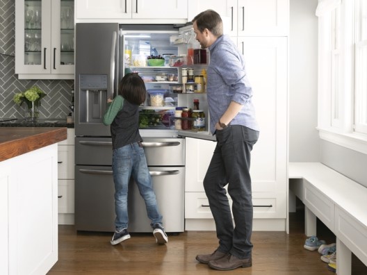 Dad and son with open 4-door refrigerator