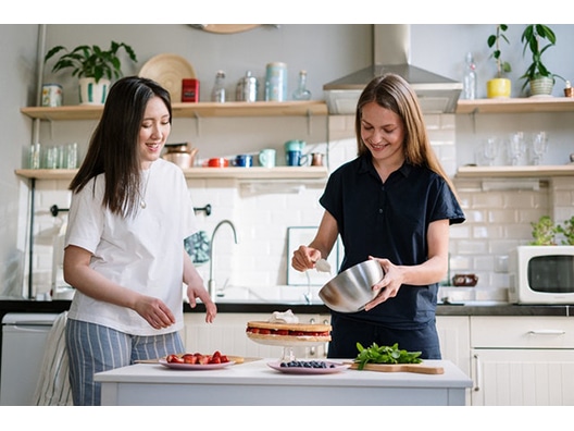 Two Young Women Cooking in Home Kitchen