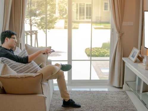 Man Watching TV in Sunroom