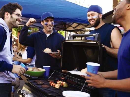 Jovial Dudes in Football Gear Gathered Around a Barbecue