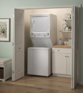 A laundry center inside a laundry alcove with doors