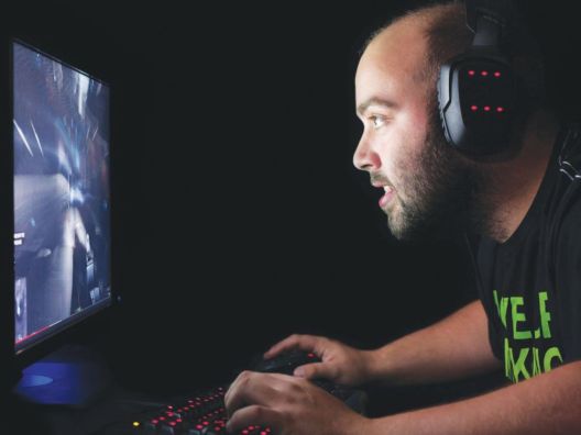Guy gaming on a desktop computer