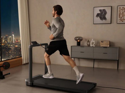 A man running on a foldable treadmill.