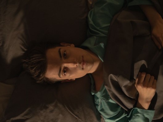Guy lying awake in bed
