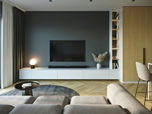 A modern looking living room with a couch, TV, and soundbar.