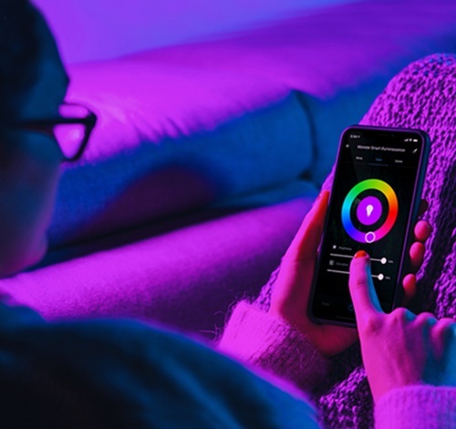 A person adjusting their lighting from their phone.
