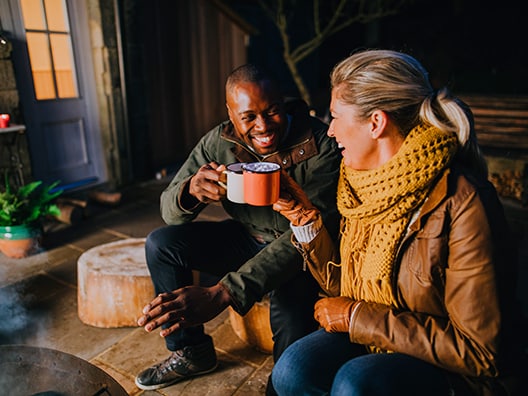 A man and a woman enjoying hot cocoa