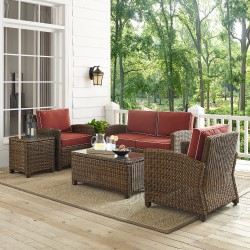 Woven patio conversation set with dark orange cushions