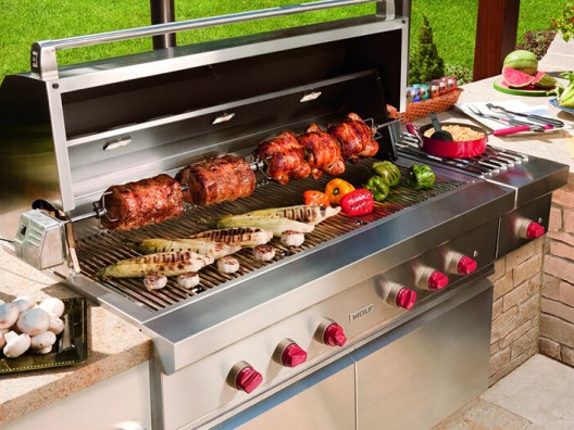 An outdoor kitchen setup featuring a built-in grill and side burner