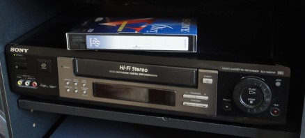 A VCR with a VHS tape on top of it