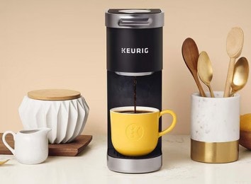 Keurig coffee maker dispensing coffee into a yellow mug