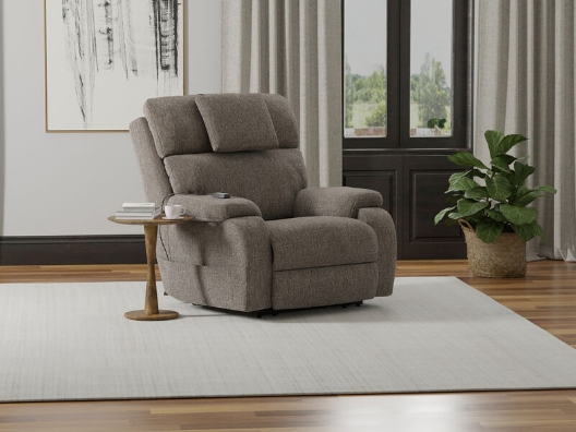 A recliner next to a side table on a rug.