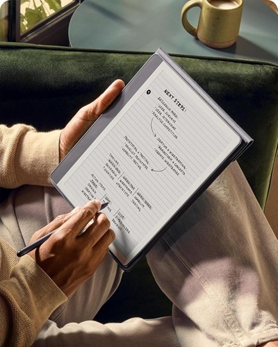 Someone holding a tablet and taking notes on it with a stylus.