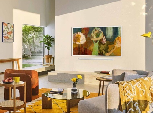 A vibrant living room with a design focused TV on a wall displaying art.