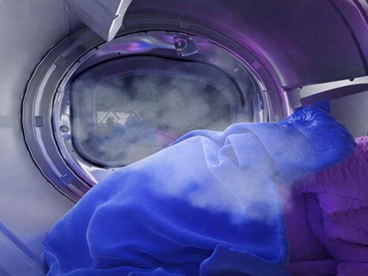 Clothes in a dryer that is running a steam cycle.